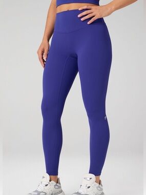 Fabletics High-Waisted Leggings in a vibrant periwinkle or sapphire blue.